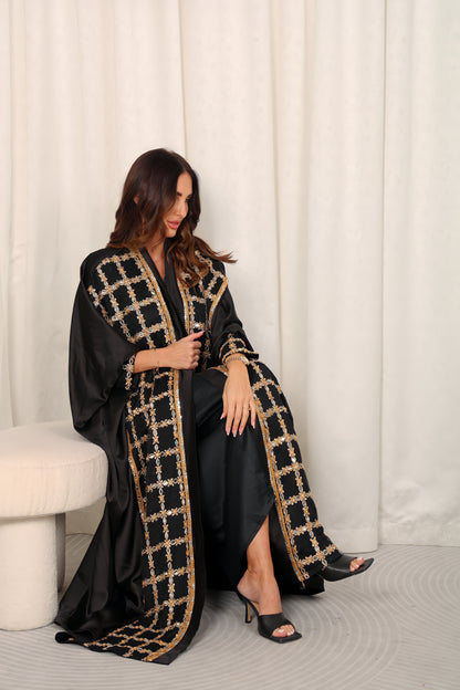 Black silk Abaya embroidered with gold stones and mirrors